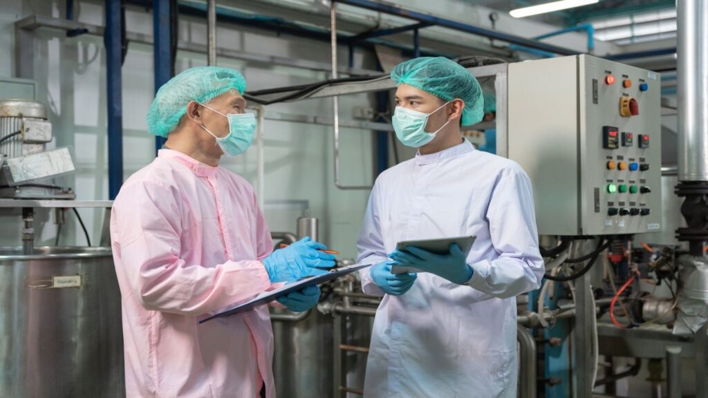 Quality technicians discussing coconut quality results